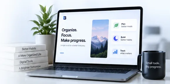 A laptop reading “Organize. Focus. Make progress.” beside books titled Better Habits, A More Organized Life, Digital Tools and A Brighter Tomorrow, and a mug reading “Small tools. Big progress.”